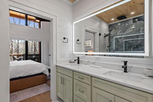 a bathroom with two sinks and a large mirror at Timber Haven in Blue Ridge