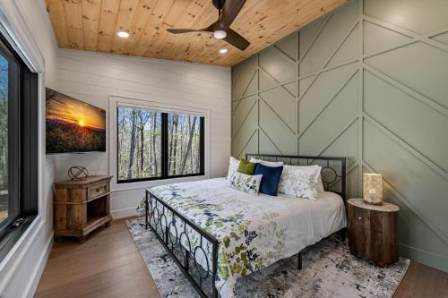 a bedroom with a bed and a window at Timber Haven in Blue Ridge