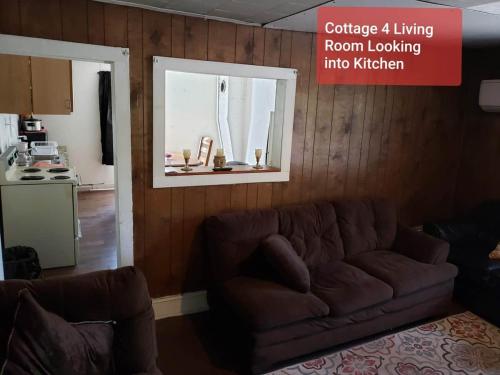 a living room with a couch and a kitchen at Cottage 4 Duplex In Eckman ATV Fun and Rentals! in Northfork