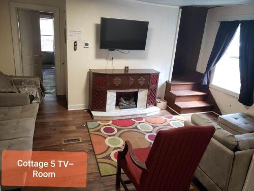 a living room with a couch and a fireplace at Cottage 5 Duplex in Eckman ATV Fun and Rentals! in Northfork