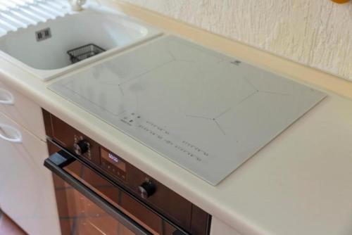 a kitchen counter with a sink on top of it at Casa C'era una volta in Costa Volpino