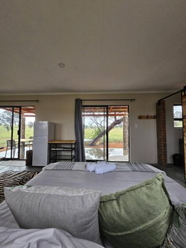 a bedroom with a large bed with a large window at Troupant - Luxury Bush Unit in Askham