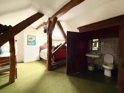 a bathroom with a toilet in a room at Former riverside rectory in Nanteau-sur-Lunain