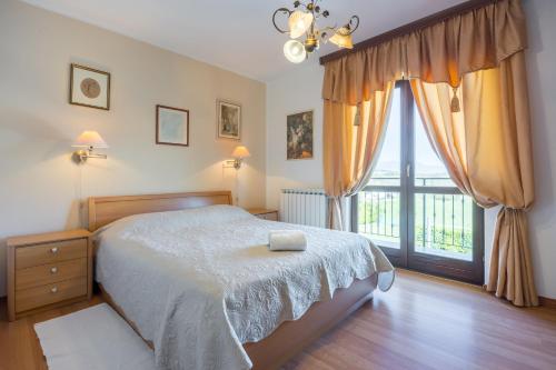 a bedroom with a bed and a large window at Villa Sofia with Private Pool in Pazin