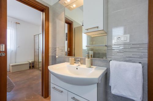 a bathroom with a white sink and a mirror at Villa Sofia with Private Pool in Pazin