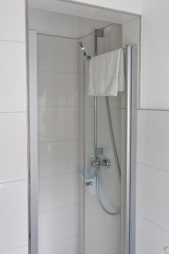a shower in a bathroom with a glass door at Hotel Sonnenklause in Travemünde