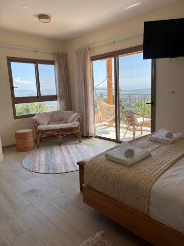 a bedroom with a bed and a large window at sunrise valley - זריחת העמק in Yavneʼel