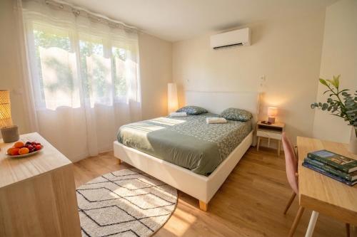 a small bedroom with a bed and a table at Villa 10-14 guests - 180m2 - private forest - CDG 7min - Disney 20min in Claye-Souilly