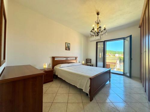 a bedroom with a bed and a balcony at Mirto House in Cardedu