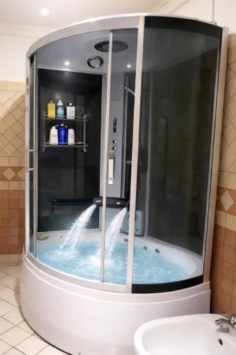 a bathroom with a tub with water in it at Luxury apartment and duplex in Ouarzazate