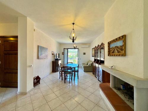a kitchen and living room with a table and chairs at Mirto House in Cardedu