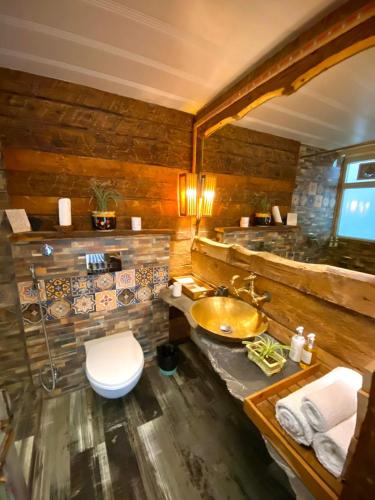 a bathroom with a sink and a toilet at MeenaBagh Villa Rooms & Cafe in Shimla