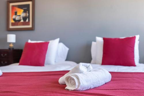 a hotel room with two beds with towels on the bed at Incredible view - T2 Ribeirinha in Portimão