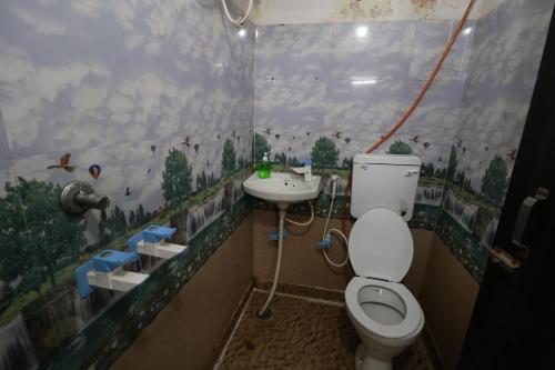 a bathroom with a toilet and a sink at Hotel Yuvraj 5 Mints walking from Rajendra Nagar Metro Station in Ghaziabad