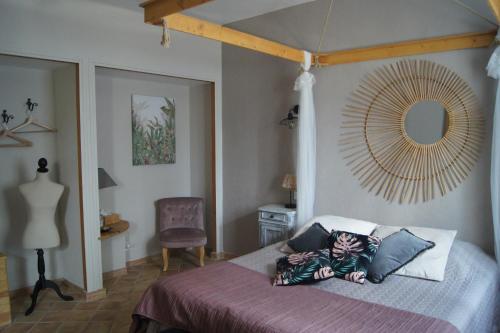 a person laying on a bed in a bedroom at L’Antre d’Eux in Carcassonne
