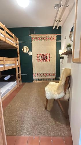 a room with two bunk beds and a chair at Cwmcarn Hotel & Bunkhouse in Cwmcarn