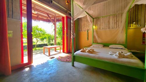 a bedroom with a bed with towels on it at Bungalow Bleu Villa Luna Nosy Be in Nosy Be