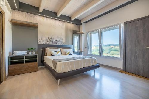 a bedroom with a large bed and a large window at Alfiri 890 in Santa Maria Pietrafitta
