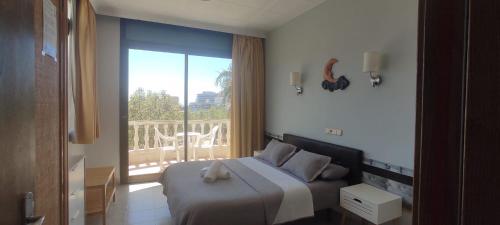 a bedroom with a bed with a view of a balcony at Hotel Bonsol ADULTS ONLY in Lloret de Mar