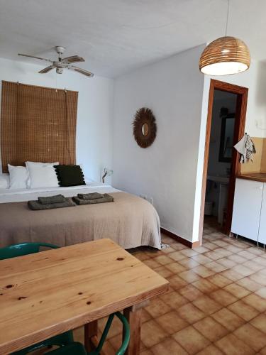 a bedroom with a bed and a wooden table at Residence Can Confort Formentera in Sant Francesc Xavier