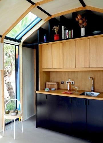a kitchen with a sink and a counter top at Designer Cabin With Shared Pool In Bras in Bras