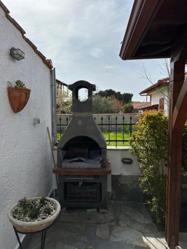a grill in a yard with a pot and a fence at Toroni home in Toroni