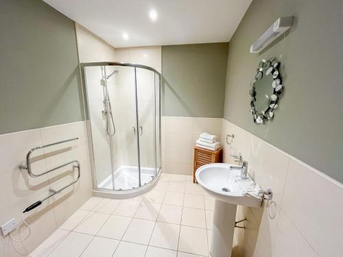 a bathroom with a shower and a sink at Apple Tree Lodge in Errol