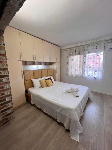 a bedroom with a large white bed in a room at OM Center Apartments Tirana in Tirana