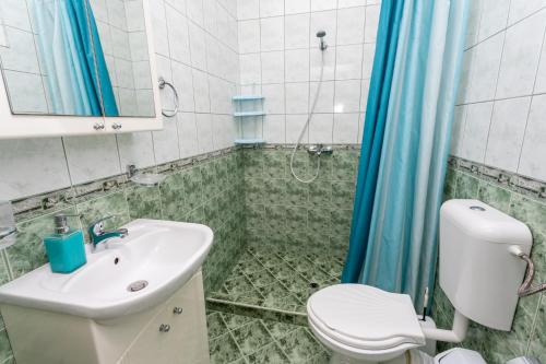 a bathroom with a sink and a toilet and a shower at Apartment DESi in Balchik