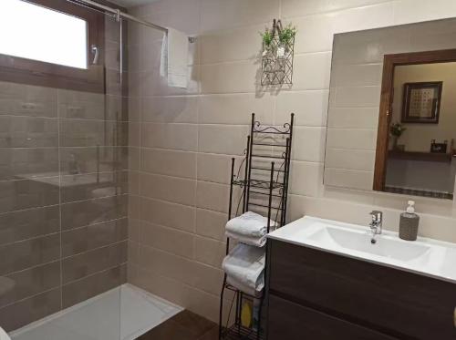 a bathroom with a sink and a shower and a sink at Casa Belén Javierre de Bielsa in Bielsa