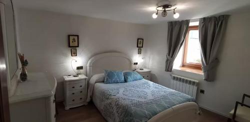 a bedroom with a bed and a sink and a window at Casa Belén Javierre de Bielsa in Bielsa