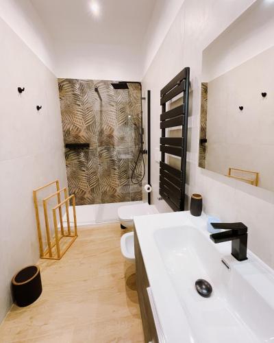 a bathroom with a white sink and a toilet at REGINA ANNA HOME in Bari