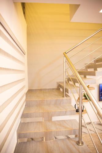 a staircase in a house with wooden floors and yellow walls at SARALIS Home in Abidjan
