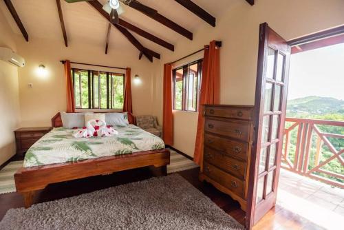 a bedroom with a bed with a dresser and a window at Careffe Escape Hideaway in Monchy