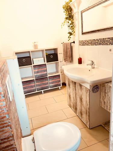 a bathroom with a toilet and a sink at Pension Nazli Lübeck in Lübeck
