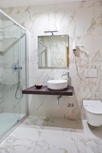 a bathroom with a sink and a shower and a toilet at Hotel Castello in Venice