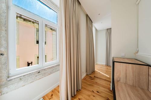 an empty living room with a large window at GS Chiado Boutique Studios & Suites in Lisbon