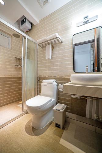 a bathroom with a toilet and a sink and a shower at Samann Blue in Hulhumale