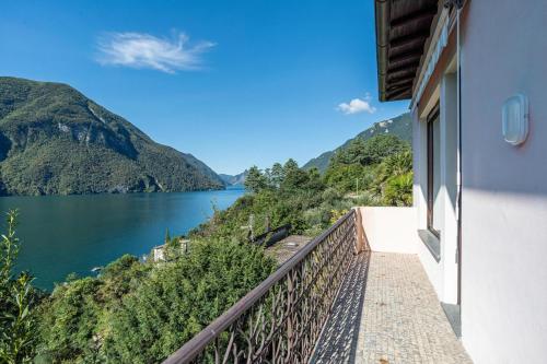 a balcony with a view of a lake and mountains at Il Tentione in Valsolda