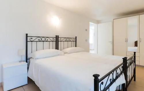 a bedroom with a large white bed with white pillows at appartamenti ceccherini debora luna in Malcesine