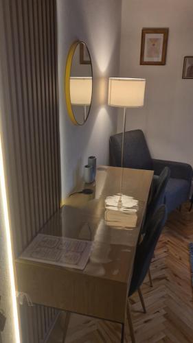 a desk with a lamp and a chair in a room at House Dado in Jezerce
