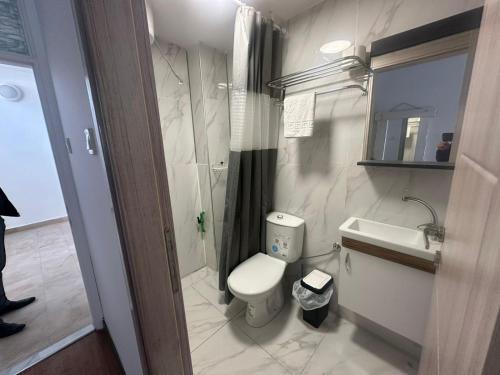 a small bathroom with a toilet and a sink at Old Town Apart in Budva