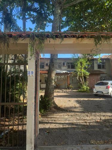 an open gate to a yard with a tree at Apartamento 70 metros do mar in Florianópolis