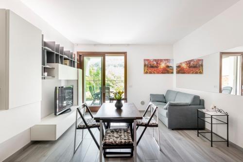 a living room with a table and a couch at EASYLIFE - Como - Crotta 3 - Argegno in Argegno