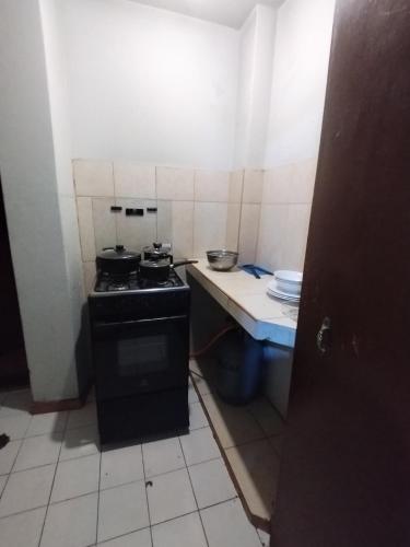 a small kitchen with a stove and a counter at MNk HOTEL in Arequipa