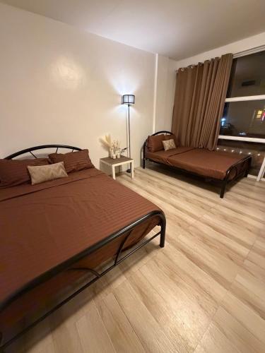 a bedroom with a bed and a couch at Sierra Monte Private Hot Spring Resort in Calamba