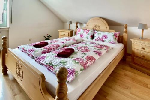 a bedroom with a large bed with a wooden frame at Wiesenhaus, Ferienhaus in Manderscheid