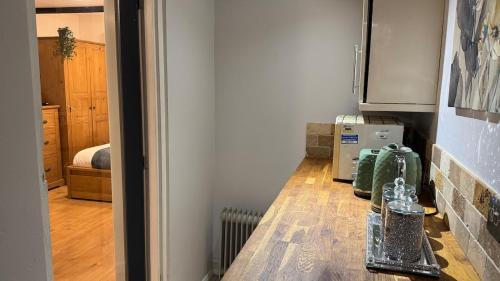 a kitchen with a table in a room at Hidden Gem in Foots Cray