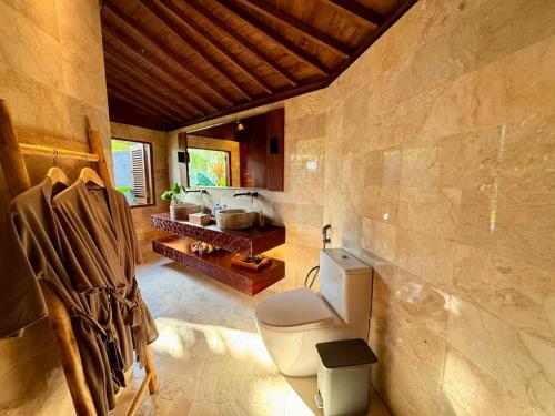 a bathroom with a toilet in a room at Wanataru Sidemen Villas in Sidemen