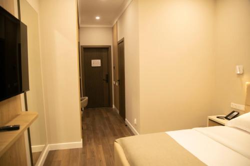 a hotel room with a bed and a bathroom at Aristocrat Hotel in Kapchagay
